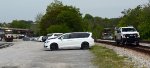 CSX hi-rail truck with NS yard job E19 in the background.  Conductor is walking his train